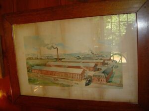 Vintage industrial factory painting depicting historic manufacturing plant with smokestacks and factory buildings, showcasing early 20th-century industrialization.