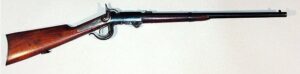 A vintage single-shot rifle with wooden stock and long barrel, designed for shooting sports and hunting.