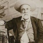 Judge Roy Bean, circa 1885, seated with law book in hand