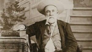 Judge Roy Bean, circa 1885, seated with law book in hand