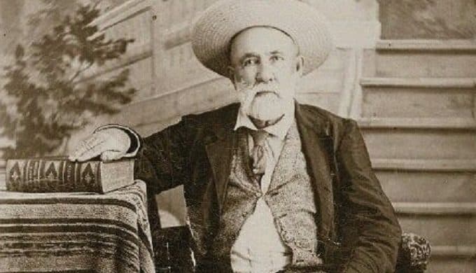 Judge Roy Bean, circa 1885, seated with law book in hand