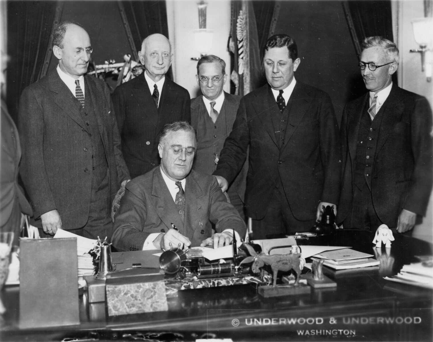 President Franklin D. Roosevelt signing legislation in 1934 — the same year the NFA suppressor tax was enacted