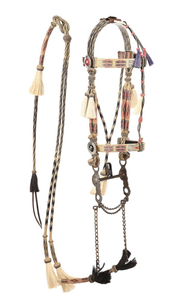 Hitched-horsehair bridle with a kissing-bird-style half-breed bit, made in a Montana prison, in bright colors on a black-on-cream ground. Estimate $8,000–$10,000.